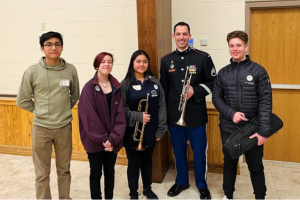  students standing alongside West Point band member
